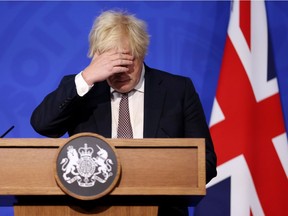 Britain's Prime Minister Boris Johnson gestures as he speaks during a press conference on the new Omicron coronavirus variant in London on Saturday, Nov. 27, 2021.