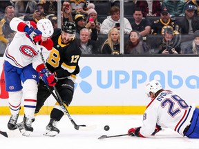 Bruins' Nick Foligno (17) and Canadiens' Ben Chiarot (8) fight for the puck during the first period at TD Garden in Boston on Sunday, Nov. 14, 2021.