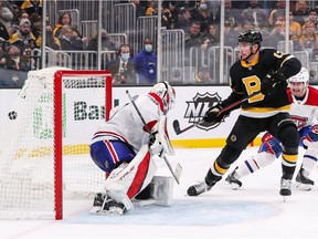 Bruins' Charlie Coyle (13) scores a goal during the third period against the Canadiens  goaltender Samuel Montembeault at TD Garden in Boston on Sunday, Nov. 14, 2021.