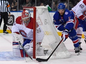 Canadiens goaltender Cayden Primeau hugs to post to stop a wraparound attempt by Rangers defenseman Patrik Nemeth Tuesday night at Madison Square Garden.