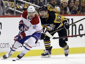 Canadiens' Jonathan Drouin (92) moves the puck against Penguins' Teddy Blueger (53) during the second period at PPG Paints Arena on Saturday, Nov. 27, 2021, in Pittsburgh.