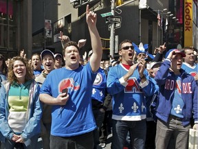 Quebec Nordiques fans react to a billboard they rented in Times Square in New York City on April 9, 2011, to pressure the NHL to put a team in Quebec City.