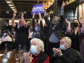 Supporters of Bruno Marchand react Sunday night as their candidate passes Marie-Josée Savard in voting results to become the new mayor of Quebec City.