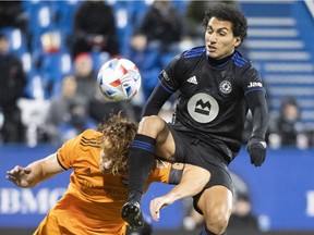 CF Montréal's Ahmed Hamdi, right, challenges Dynamo's Tim Parker during first half at Saputo Stadium on Wednesday.