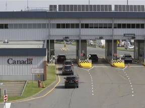 Cars with U.S. license plates enter Canada at the Stanstead border crossing as seen from Derby Line, Vt., on Aug. 9, 2021.  Starting Monday, Nov. 8, 2021, Canadians will be able to cross in the opposite direction.