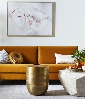Large art pieces, textured velvet fabrics and bold accessories are a few home decor trends for the new year. Brass cylinder side table, $200, HomeSense.ca.