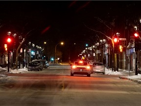 Montreal police patrol Wellington St. during curfew on Saturday, January 23, 2021.