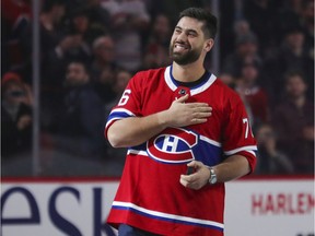 Super Bowl-winning Kansas City Chiefs offensive-lineman Laurent Duvernay-Tardif touches his heart while being cheered before Montreal Canadiens game against the Arizona Coyotes in Montreal on Feb. 10, 2020.
