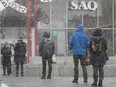 Customers brave the snow outside the Jean-Talon Market's SAQ outlet in 2020.