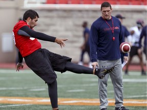 Montreal Alouettes special-teams coordinator Mickey Donovan watches as kicker Enrique Yenny punts during first day of rookie camp in Montreal on May 15, 2019.