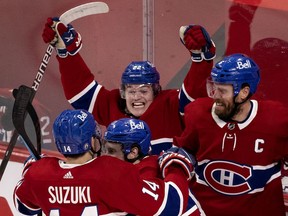 Montreal Canadiens' Cole Caufield, centre, celebrates with Nick Suzuki, Brendan Gallagher and Shea Weber, right, after beating the Vegas Golden Knights in Game 6 to advance to the Stanley Cup final in Montreal on June 24, 2021.