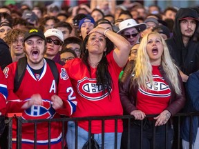 Disappointment can be read on the faces of Canadiens fans outside the Bell Centre in Montreal on July 7, 2021, as the Canadiens were defeated by the Lightning 1-0 in Tampa to win the Stanley Cup.