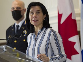 Mayor Valérie Plante speaks at a press conference in Montreal Monday, November, 29, 2021 as SPVM deputy chief Vincent Richer listens. They announced that Montreal will hold a forum on armed violence in January.