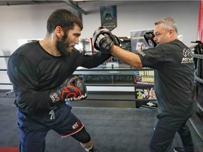 Light-heavyweight world champion Artur Beterbiev works with trainer Marc Ramsay at Ramsay's gym in Montreal on Dec. 1, 2021, in preparation for his coming fight.