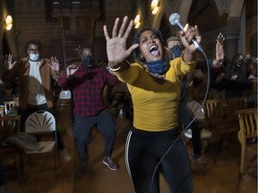 Saiswari Virahsammy and other members of the Montreal Gospel Choir rehearse under the guidance of director Carol Bernard at the Church of St. John the Evangelist in Montreal. The Montreal Gospel Choir's Christmas concert is Dec. 11, with the Jireh Gospel Choir.