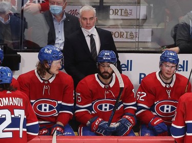 Montreal Canadiens coach Dominique Ducharme looks toward centre ice, while players Michael Pezzetta (55), Mathieu Perreault (85) and Artturi Lehkonen (62) look on following goal by Colorado Avalanche's Cale Makar during second period in Montreal on Thursday, Dec. 2, 2021.