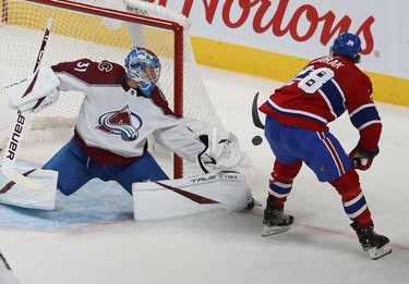 Montreal Canadiens' Christian Dvorak (28) tries for the return on Colorado Avalanche goaltender Jonas Johansson during second period in Montreal on Thursday, Dec. 2, 2021.