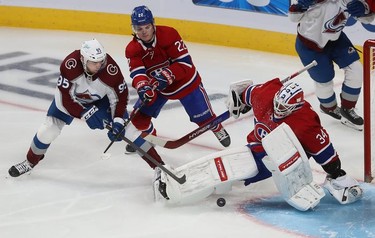Colorado Avalanche's Andre Burakovsky (95) shoots puck past Montreal Canadiens goaltender Jake Allen while Cole Caufield (22) tries to create interference during third period in Montreal on Thursday, Dec. 2, 2021.