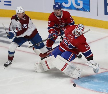 Colorado Avalanche's Andre Burakovsky (95) watches puck go past Montreal Canadiens goaltender Jake Allen and Cole Caufield (22) during play where he scored during third period in Montreal on Thursday. Dec. 2, 2021.