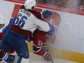 Canadiens' Josh Anderson (17) is slammed into the boards by Avalanche's Kurtis MacDermid during the second period Thursday night. Anderson was injured on the play andis expected to miss two to four weeks.