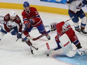 Colorado Avalanche's Andre Burakovsky (95) shoots puck past Montreal Canadiens goaltender Jake Allen while Cole Caufield (22) tries to create interference during third period NHL action in Montreal on Thursday December 2, 2021.