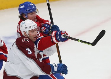 Montreal Canadiens' Tyler Toffoli (73) holds back Colorado Avalanche's Jack Johnson (3) by bringing up his stick during first period action in Montreal on Thursday, Dec. 2, 2021.