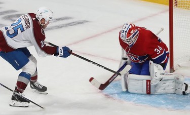 Montreal Canadiens goaltender Jake Allen stops shot by Colorado Avalanche's Logan O'Connor (25) during first period action in Montreal on Thursday, Dec. 2, 2021.