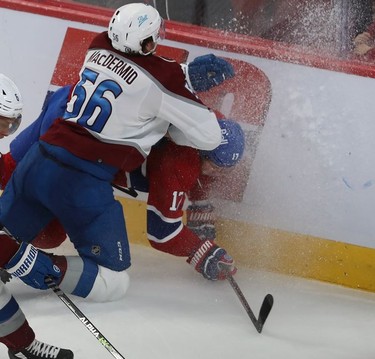 Montreal Canadiens' Josh Anderson (17) is slammed hard into the boards by Colorado Avalanche's Kurtis MacDermid (56) during second period in Montreal on Thursday, Dec. 2, 2021.