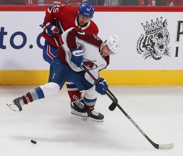 Montreal Canadiens' Ryan Poehling (25) and Colorado Avalanche's Devon Toews (7) try to get to the puck during second period in Montreal on Thursday, Dec. 2, 2021.