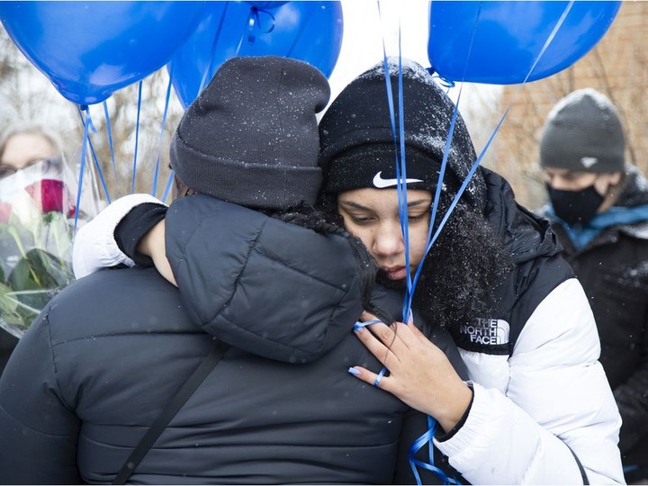  People hug prior to a Long Live Jannai walk on Saturday. Jannai Dopwell-Bailey, 16, was stabbed to death outside his school in October.