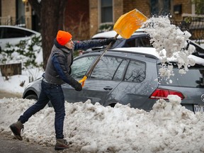 Shareef Elshafei digs out his car after the first significant snowfall of the season in Montreal on Dec. 6, 2021.
