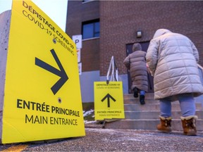 People enter a COVID-19 testing centre in Lachine on Tuesday, Dec. 7, 2021.