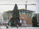 The construction of condos, by developer Sotramont, can be seen behind Brasserie Le Manoir at the corner of Hymus and St-Jean boulevards in Pointe-Claire on Wednesday.