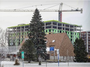 Condo construction, by promoter Sotramont, can be seen behind Brasserie Le Manoir at the corner of Hymus and St-Jean boulevards in Pointe-Claire on Wednesday.