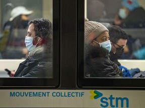 Masked subway riders at the Guy-Concordia Metro stop in Montreal Friday December 10, 2021.