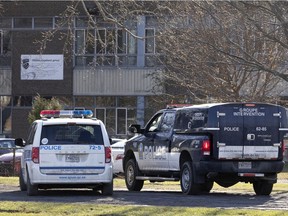 Montreal police keep an eye over Ecole Cavalier De La Salle in Montreal, on Monday, Dec. 13, 2021.