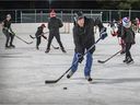 Pointe-Claire Mayor Tim Thomas, elected last month, takes a shot on the new refrigerated hockey rink in Valois Park on Monday.