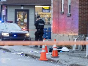 Cones mark evidence at the scene where police shot a man who they believe had attacked two people with a knife in the Ville St-Pierre district in Montreal Thursday Dec. 16, 2021.