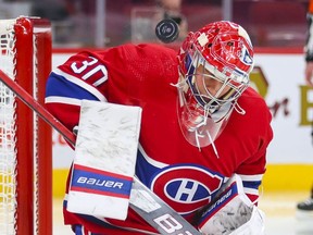 Montreal Canadiens' Cayden Primeau takes a shot off his shoulder during second period at the Bell Centre on Thursday, Dec. 16, 2021.