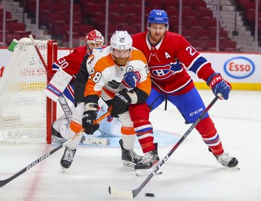 Montreal Canadiens' Jeff Petry pokes the puck away from Philadelphia Flyers' Claude Giroux during second period at the Bell Centre on Thursday, Dec. 16, 2021.