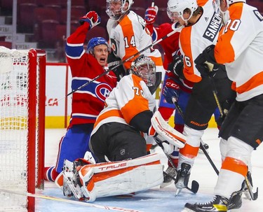 Montreal Canadiens Jesse Ylonen celebrates team-mate Laurent Dauphin's goal during third period at the Bell Centre on Thursday, Dec. 16, 2021. Flyers goalie Carter Hart looks behind him for the puck.