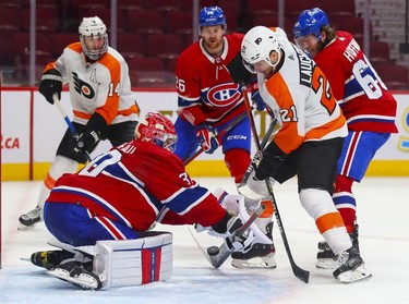 Montreal Canadiens' Cayden Primeau makes a save on shot by Philadelphia Flyers' Scott Laughton during overtime at the Bell Centre on Thursday, Dec. 16, 2021.