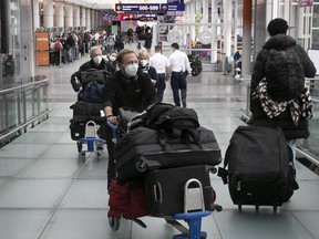 Passengers make their way through the departure area at Montreal's Trudeau airport on Dec. 17, 2021.