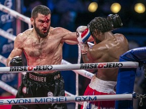 A bloodied Artur Beterbiev hits Marcus Browne during their light-heavyweight title fight at the Bell Centre in Montreal on Saturday, Dec. 18, 2021. Beterbiev, based out of Montreal, knocked out Browne in the 9th round.