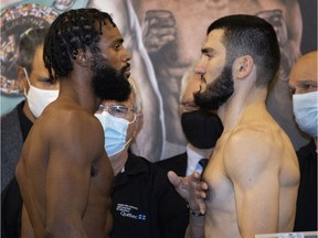 Contender Marcus Browne, left, and Montreal champion Artur Beterbiev after weigh-in in Montreal, on Dec. 16, 2021.