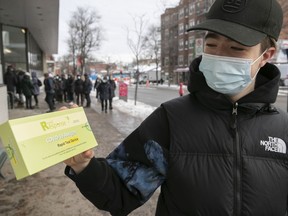 Edouard Coulombe shows is COVID rapid test he received at pharmacy in Outremont on Monday.