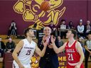 George Rembali Jr. (center) performs the ceremonial tip-off between team captains Olivier Simon (left) and Sam Jenkins during the 2020 Rembali Cup basketball rivalry game on Feb. 15, 2020, at Concordia University.