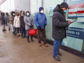 People line up at the COVID-19 testing clinic at the Gerry-Robertson Community Centre in the Pierrefonds-Roxboro on Wednesday, December 22, 2021.