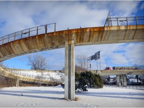 The damaged pedestrian walkway at Sources Blvd. overpass in Pointe-Claire, on seen on Dec. 21, 2021. The walkway was damaged in a car accident.