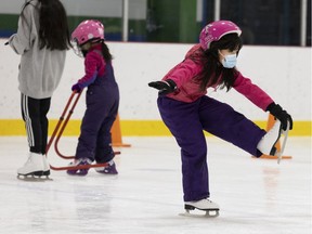 Seven-year-old Boran Li practices her figure skating moves during holiday skating hours at the Kirkland Sports Complex on Sunday, December 19, 2021.